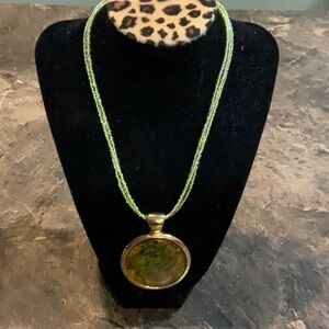 Costume jewelry. Pendant with green and gold tones